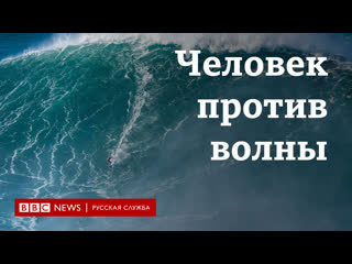 На гребне гигантской волны cерфингисты против стены воды у берегов португалии