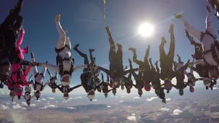 World record group skydive׃ 65 female jumpers take epic flight upside down!