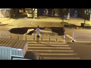 Man on a scooter plunges into sinkhole