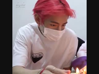 Red haired taehyung in a plain white shirt a matching red sweatpants with no make up on his face being the cutest baby boy ever