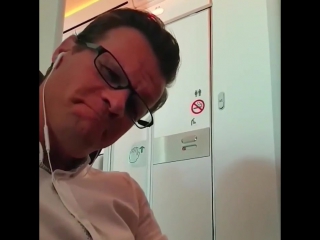 Two passengers are leaving the toilet on a virgin atlantic flight