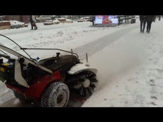 Clearing snow from walking paths of city