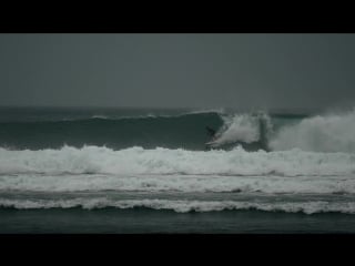 Ivan fominykh surfing in serangan beach, bali, indonesia