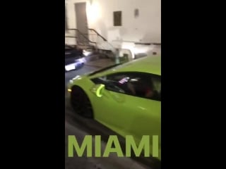 Kim in miami last night wearing a neon wig cruising in a neon lambo any guesses for wha