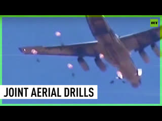 Syrian and russian paratroopers fly in joint drill