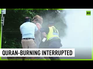 Woman with fire extinguisher interrupts quran burning in stockholm