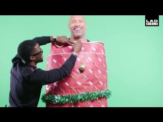 Jumanjis dwayne the rock johnson and kevin hart dress each other with christmas decorations