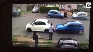 Impressive strong man picks up a car in parking dispute