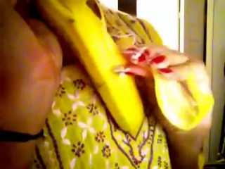 Long red nails peeling banana