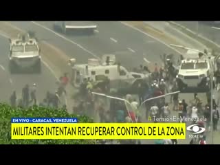 Breaking a military vehicle runs over pro guaido protesters in caracas, venezuela