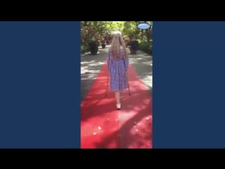 Beautiful amputee girl crutching on red carpet