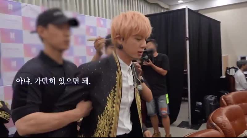 Staff asked seokjin to be calm but seokjin refused so he should held his arms im