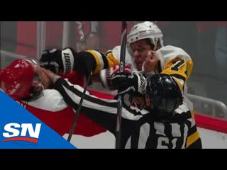 Evgeni malkin and brenden dillon keep fighting as referee tries to separate them