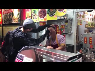 Hong kong student helps elderly food vendor wash his eyes after tear gas assault; another student gives him goggles