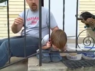 Boy stuck in fence