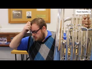Youtuber trent hamilton dropping a contrabass trombone while comparing it to a tuba