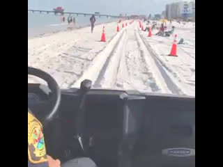 Police on patrol at clearwater beach in florida after it reopened to the public as the state eases coronavirus restrictions