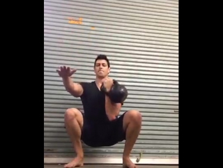 24kg alternating kettlebell curl from squat position exercise try to curl slowly while maintaining a solid squat stance