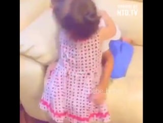 Littel brother combs and ties sister's hair