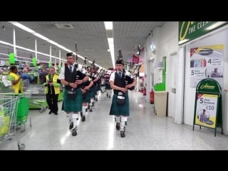 Newtonhill pipe band surprise shoppers in asda portlethen with flashmob walk through supermarket