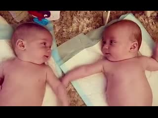 Adorable 4 month old identical twins notice each other for the first time and have a little chat