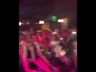 Skimasktheslumpgod jumps from the balcony into the crowd at his show