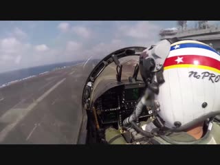 Pov of a fighter jet landing on an aircraft carrier