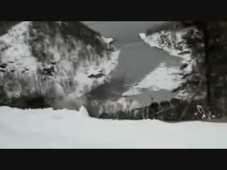 Truck being towed slides off a snowy cliff