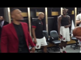 Damian lillard presenting coach stotts with tonight's game ball after picking up his 150th win