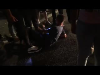 The antifa blm mob assaults him and makes him sit in the ground while they search his belongings