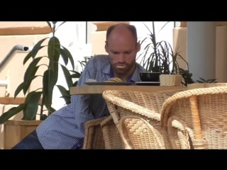 A man with a disability eats at a table in a cafe beximaxi