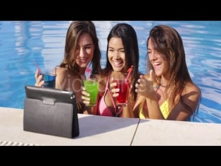 Three bikini clad friends toasting pool side by daniel dash