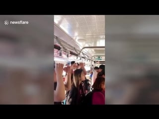 Chinese woman uses plunger as a makeshift handle on bus