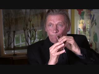 Peter bastian is playing a straw like a double reed instrument