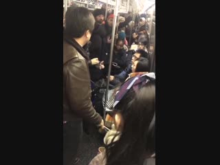 White woman starts beating asian woman with an umbrella and calling her racial slurs after bumping into her on the new york subw