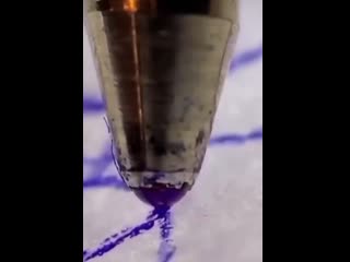 Closeup of a ballpoint pen in action