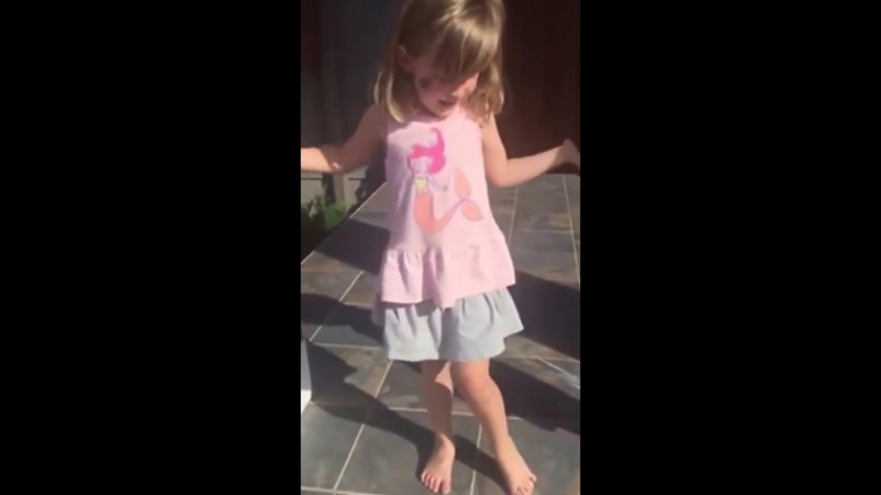 Little girl has drawn a family of giraffes on a stair at the entrance of a house
