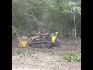 Uses a remote controlled tracked brush cutter to clear land the front hood raises and lowers letting him tackle bigger logs and