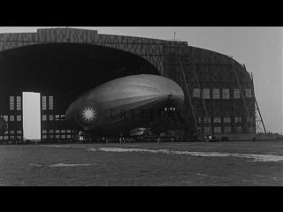 Uss los angeles is towed out from an airship hangar and is moored to a mast at stock footage