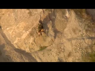 Dramatic video shows an older couple being hoisted to safety after falling down a cliff