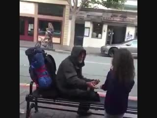 Young girl gave her meal to a homeless man