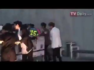 Siwon rescuing fans from a barrier that was going to fall