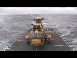 Amazing military helicopter landing on ship deck in rough seas