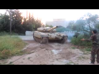 Local man tries to tame a wild syrian t 72 tank that strayed into his backyard