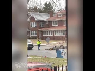 Man plays with toy excavator in middle of road