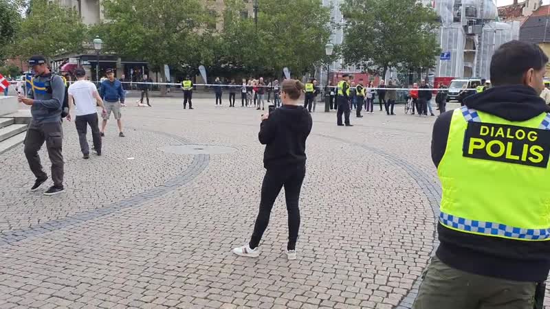 Representatives of stram kurs kick football with the koran on stor torg in malmö