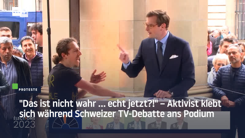 "das ist nicht wahr … echt jetzt?!" – aktivist klebt sich während schweizer tv debatte ans podium