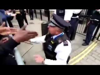 British police officer bows to his black master