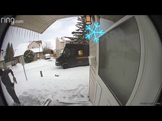 Delivery man shovels snow from customer's walkway