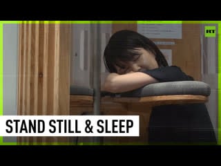 Japanese company creates vertical office pods for upright sleeping